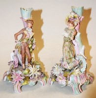 Lot 223 - A pair of Continental porcelain figural candle-...