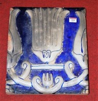 Lot 114 - A large Persian pottery tile, on a blue ground...