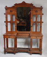 Lot 303 - A large Arts & Crafts oak mirrorback hallstand,...