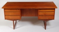 Lot 341 - A 1960s Danish teak kneehole writing desk,...