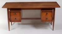 Lot 351 - A 1960s Danish teak kneehole writing desk,...