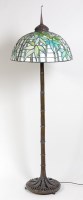 Lot 311 - A Liberty style bronze standard lamp, having...