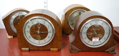 Lot 12 - A 1930s oak cased mantel clock, having...