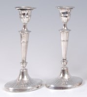 Lot 1218 - A pair of Edwardian silver candlesticks, in...