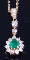 Lot 1265 - An 18ct gold, emerald and diamond set pendant,...