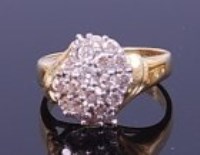Lot 1276 - An 18ct gold diamond cluster ring, arranged as...