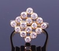 Lot 1277 - An 18ct gold diamond set dress ring, the...