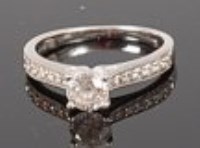 Lot 1305 - A platinum diamond solitaire ring, the four...