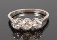 Lot 1306 - An 18ct white gold diamond three stone ring,...