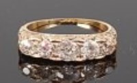 Lot 1307 - An 18ct gold diamond five stone ring, the...