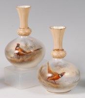 Lot 1160 - A pair of Royal Worcester porcelain bottle...