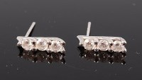 Lot 1297 - A pair of 18ct white gold diamond ear studs,...