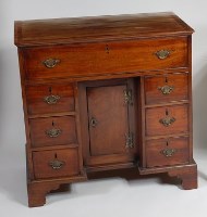 Lot 1545 - A George III mahogany kneehole writing desk,...