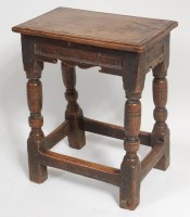 Lot 1557 - An 18th century joined oak stool, the top...