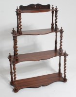 Lot 1575 - A Victorian rosewood four tier wall shelf, of...