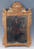 Lot 1594 - A Louis XVI provincial giltwood wall mirror,...