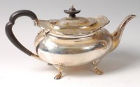 Lot 1180 - A George V silver teapot, of squat oval form,...