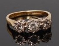 Lot 2001 - An 18ct gold diamond three stone ring, the...