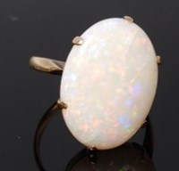 Lot 2016 - A 14ct gold opal dress ring, the oval six claw...