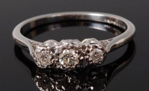 Lot 2054 - An 18ct white gold diamond three stone ring,...