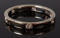 Lot 2055 - A modern platinum and diamond band ring, the...