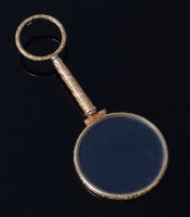 Lot 2058 - A Victorian yellow metal hand-held magnifying...