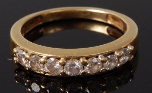 Lot 2064 - An 18ct gold diamond set half eternity ring,...
