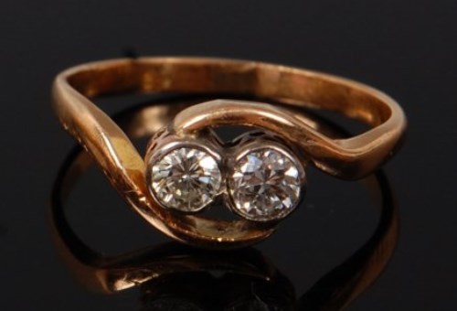 Lot 2078 - An 18ct gold diamond crossover ring, the...