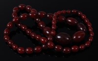 Lot 2081 - A beaded cherry amber necklace, comprising 57...