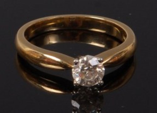 Lot 2087 - An 18ct gold diamond solitaire ring, the four...