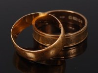 Lot 2128 - A 22ct gold wedding band, 2.8g, size J;...