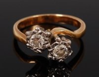 Lot 2129 - An 18ct gold diamond crossover ring, the twin...