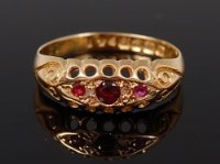 Lot 2130 - An 18ct gold garnet set ring, the three...