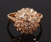 Lot 2157 - An 18ct gold diamond cluster ring, arranged as...