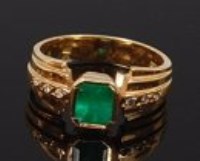 Lot 2158 - A modern 18ct gold emerald set dress ring,...