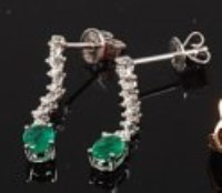 Lot 2161 - A pair of modern 14ct white gold, emerald and...