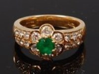 Lot 2172 - An 18ct gold, emerald and diamond flower head...