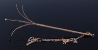 Lot 2180 - A 9ct gold engine turned swizzle stick, having...