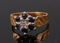 Lot 2185 - An 18ct gold, sapphire and diamond flower head...