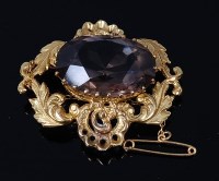 Lot 2196 - An 18ct gold and smoky topaz set brooch, the...