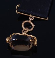 Lot 2198 - A 9ct gold and smoky topaz set swivel fob...