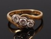 Lot 2202 - An 18ct gold and diamond three stone ring,...