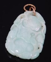 Lot 2215 - A Chinese carved pale celadon jade pendant,...