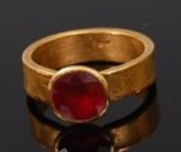 Lot 2232 - A high carat gold ruby solitaire ring, the...