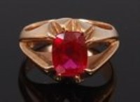 Lot 2235 - A modern 14ct gold ruby dress ring, the oval...