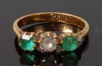 Lot 2045 - An 18ct gold, emerald and diamond set three...