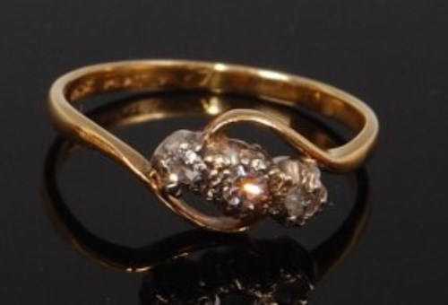 Lot 2253 - An 18ct gold diamond three stone ring, the...