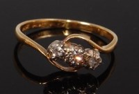 Lot 2253 - An 18ct gold diamond three stone ring, the...
