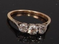 Lot 2292 - An 18ct gold diamond three stone ring, the...