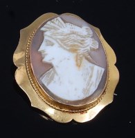 Lot 2297 - A carved shell cameo brooch, depicting profile...